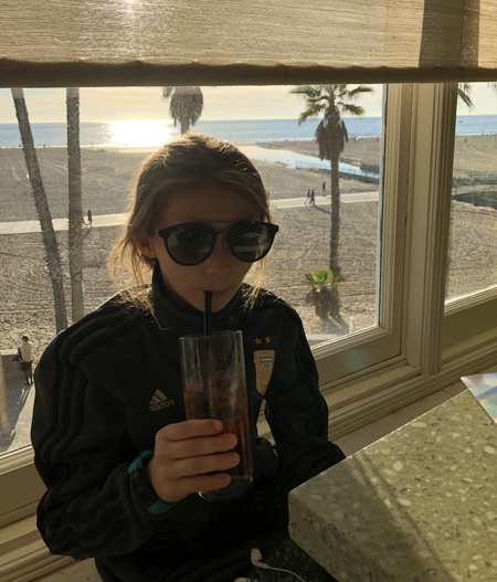 Eva wearing her shades and drinking a Roy Rogers