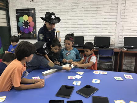 Children with iPads and cards