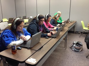 Teachers in classroom using laptops