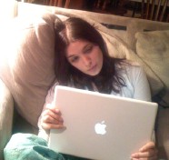 Jennifer looking sadly at the laptop