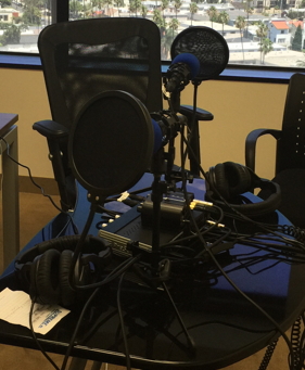 Podcast setup with mikes and headsets and audio boxes
