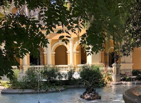 building and fountain in park next door