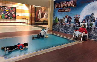kids playing at Hotel Transylvania display in the metro station