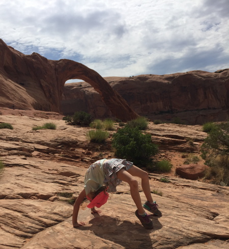 Emilia doing yoga in Arches National Park during our trip moving our startup to Minnesota