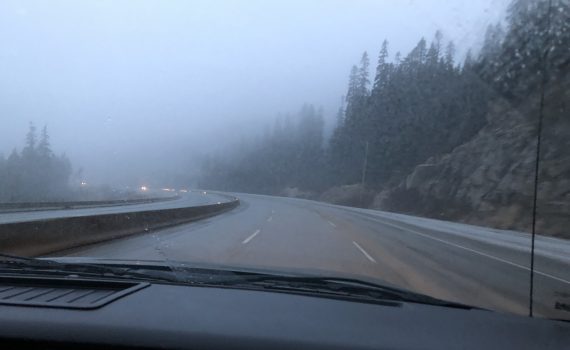 Foggy road with no traffic in the Canadian Rockies