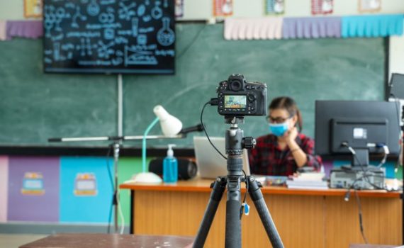 freepik.com photo of solitary masked teacher at a desk